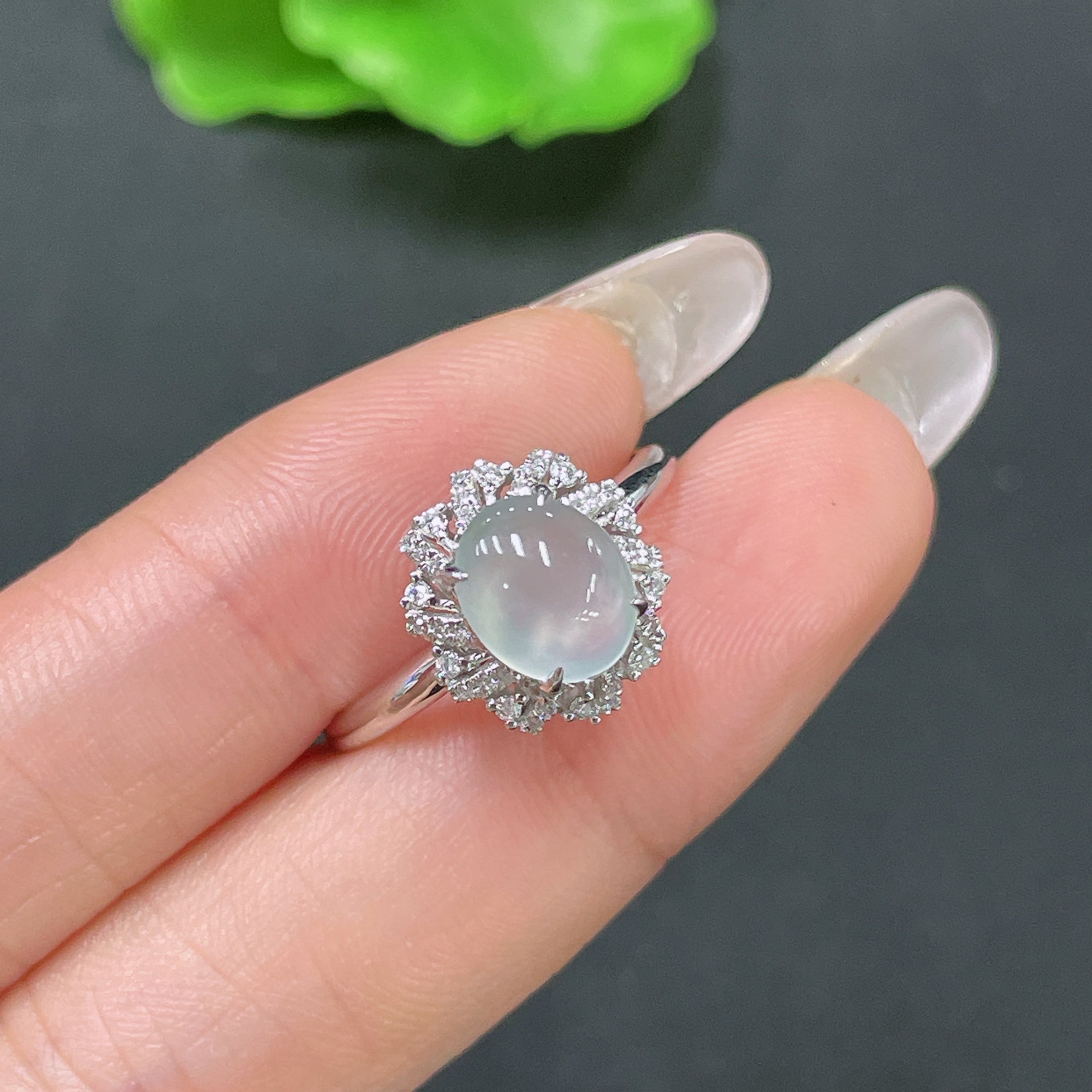 Jadeite ring with 18k gold setting and diamond accents, size 18, featuring a smooth green jade stone and elegant design.