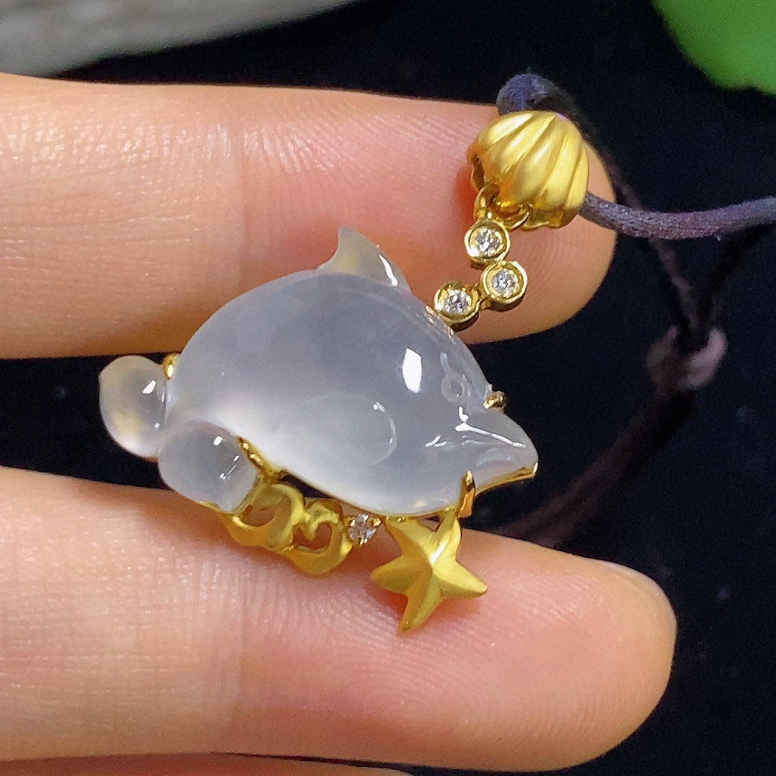 Jadeite inlaid pendant with 18K gold, diamond accents, and rope chain, weighing approximately 7.1 grams, by HKHQ.