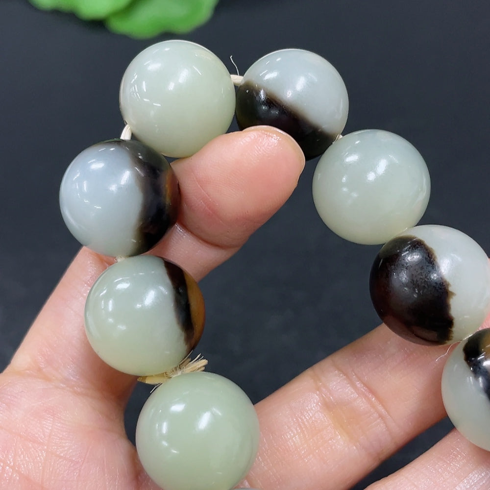 HKHQ Hetian Jade bracelet with 15.5mm beads, approximately 83g, showcasing smooth jade stones on a neutral background.