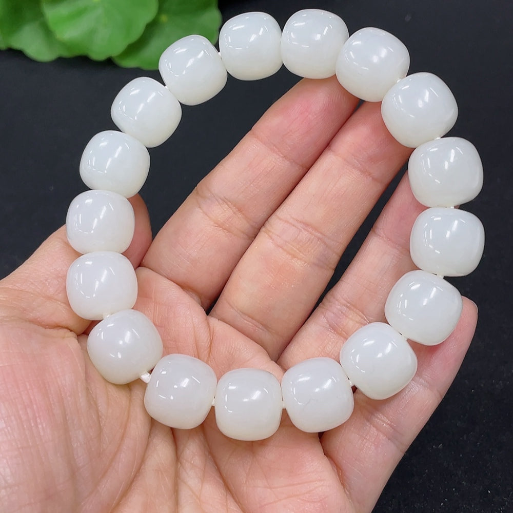 Hetian Jade bracelet by HKHQ featuring smooth, polished jade beads on a delicate strand, weighing 60.5 grams.