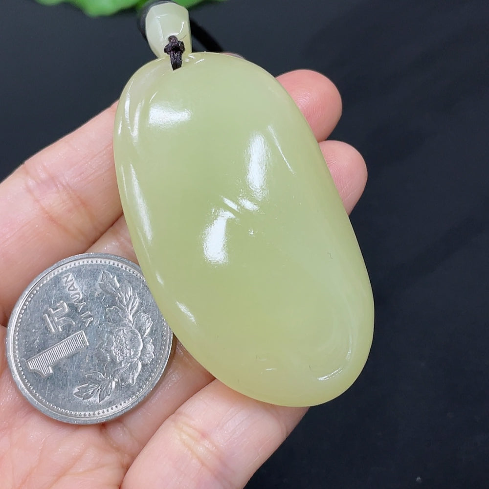 Hetian Jade freeform pendant necklace by HKHQ featuring a smooth, polished jade stone with natural curves and rich green color.