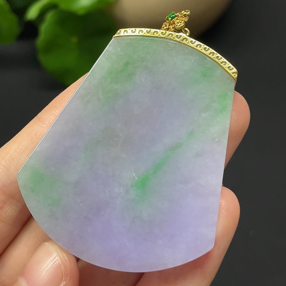 Jadeite plain pendant mounted in 18k gold, weighing approximately 22.79g, showcased with detailed close-up of the jade and gold setting.