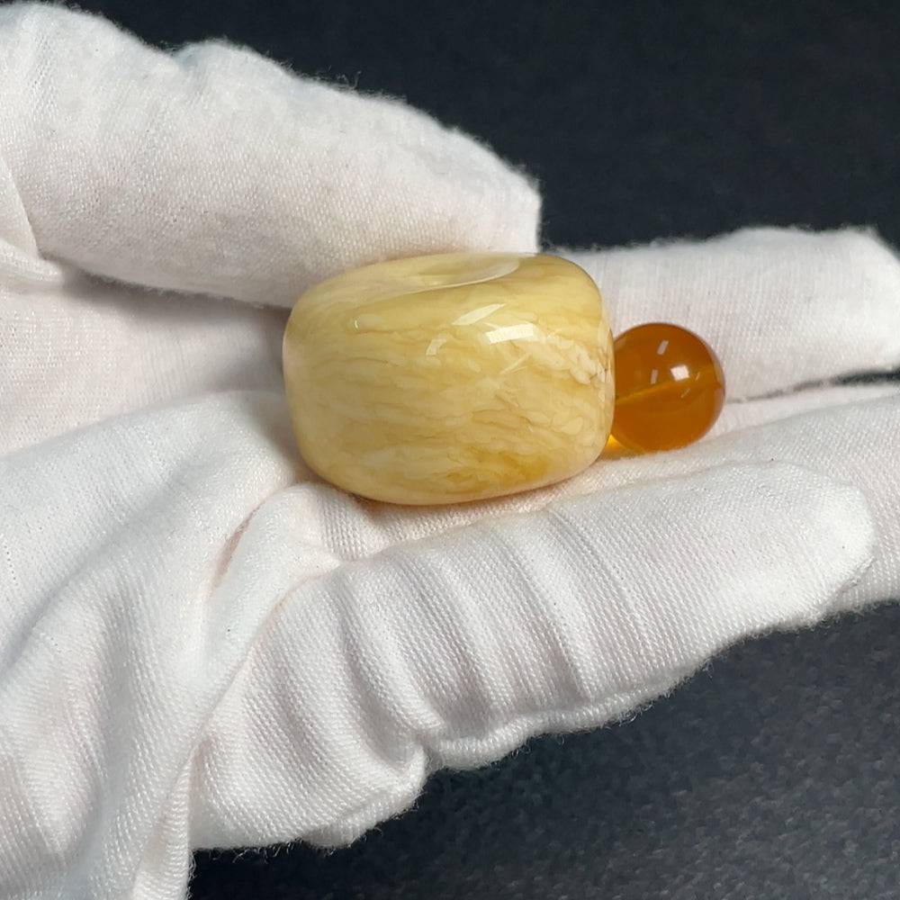 Huiliu HQ amber beeswax pendant displayed on a chain, showcasing its warm, natural amber color and handcrafted design.