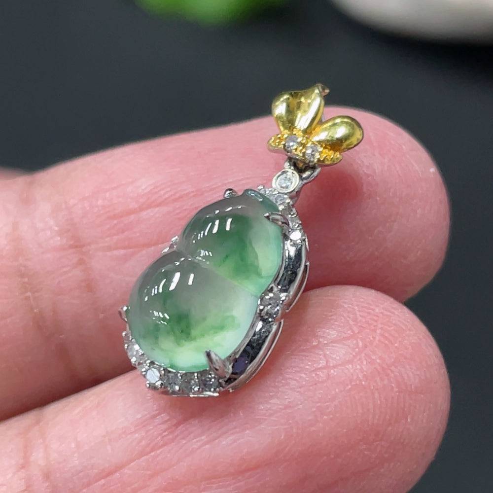 Jadeite gourd pendant from HUILIU HQ with 18k gold accents and diamond details, featuring a polished green jade surface.