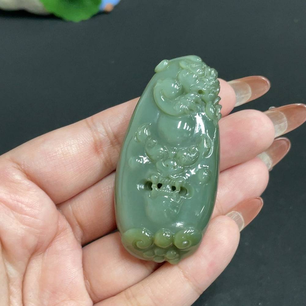 Huiliu Certified Hetian Jade Pendant featuring an auspicious beast design, showcasing intricate craftsmanship and smooth jade texture.