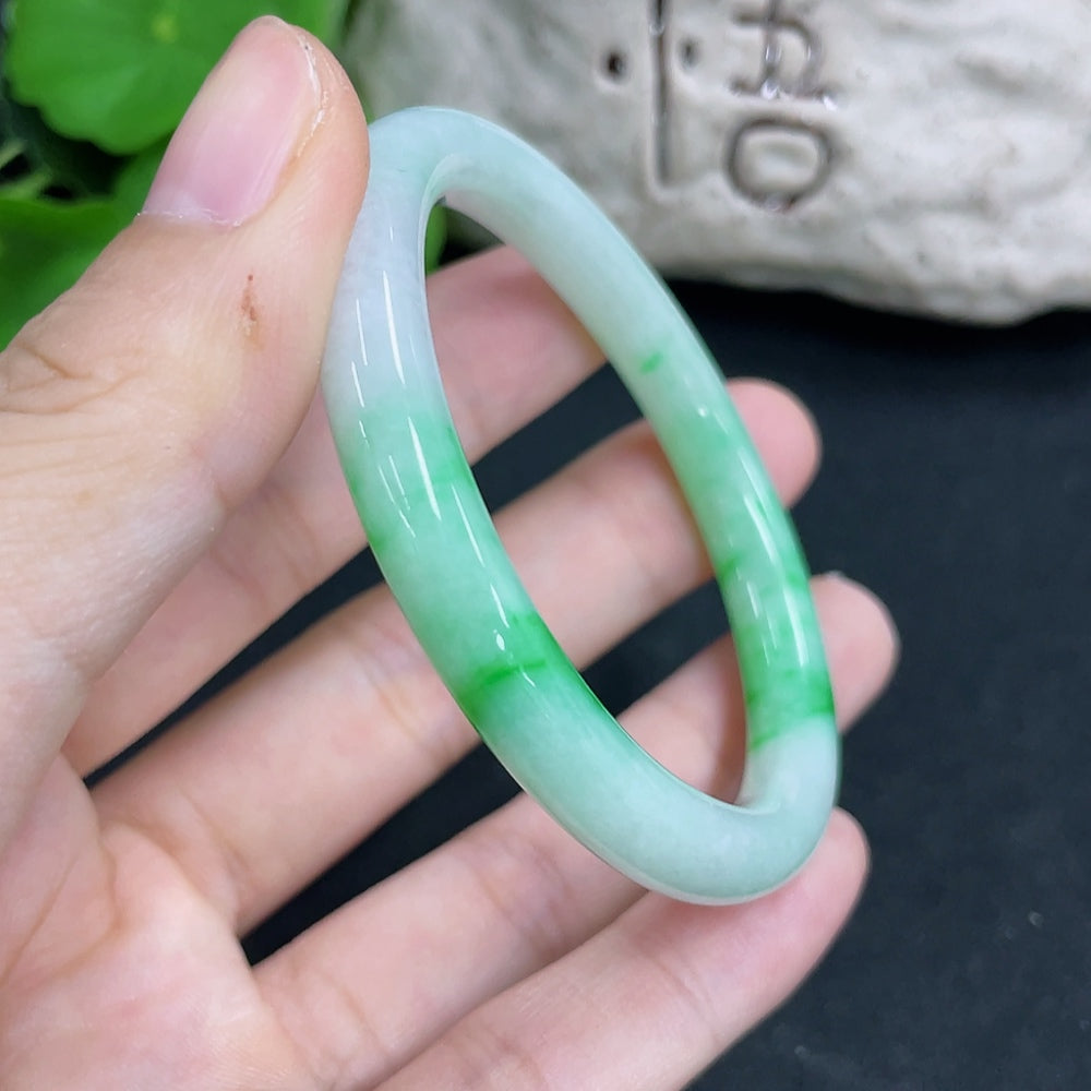 HKHQ jadeite oval bangle in size 54.2, weighing 25.8g, featuring smooth polished surface and oval shape.