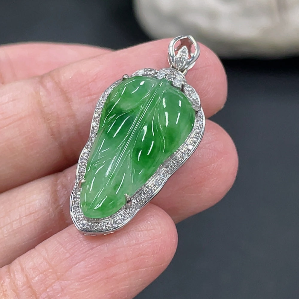 Jadeite leaf inlay pendant with 18k gold and diamond accents, weighing approximately 3g, featuring intricate craftsmanship.