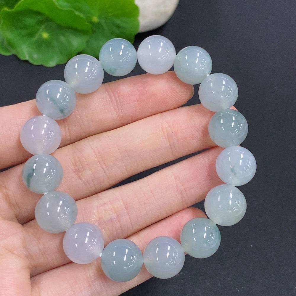 HUILIU HQ jadeite bracelet, 44.7g, 11.7mm wide, featuring smooth, polished jade stones on a flexible bracelet design.