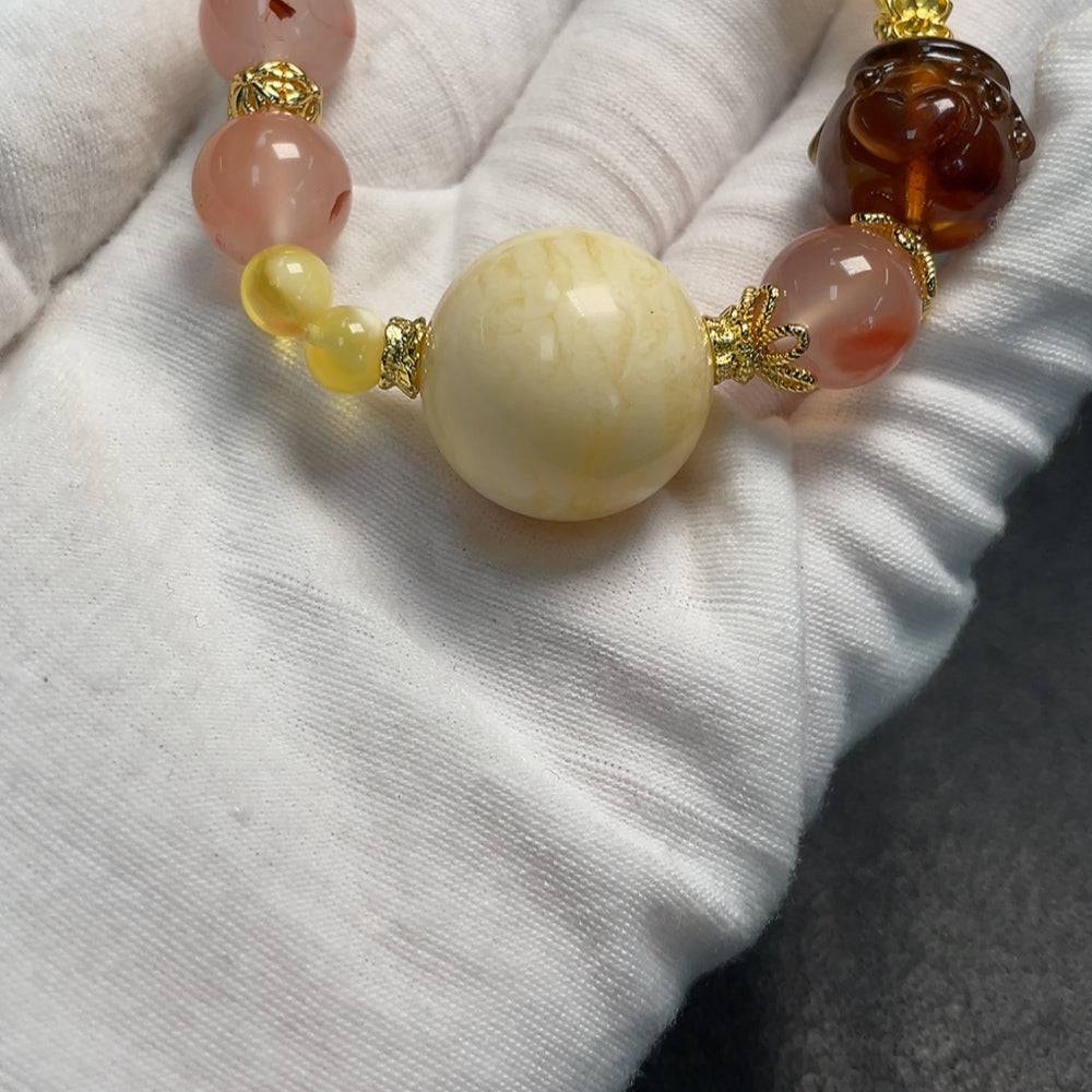 Amber beeswax bracelet with southern red agate and Hetian jade beads, crafted by HUILIU HQ, featuring natural gemstones.