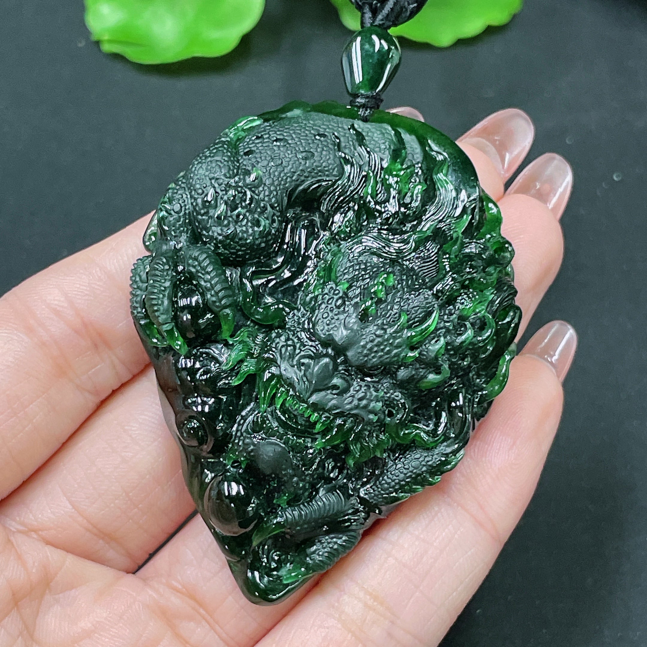 Jadeite pendant featuring a detailed dragon plaque, weighing approximately 49.58g, crafted by HUILIU HQ in vibrant green jade.
