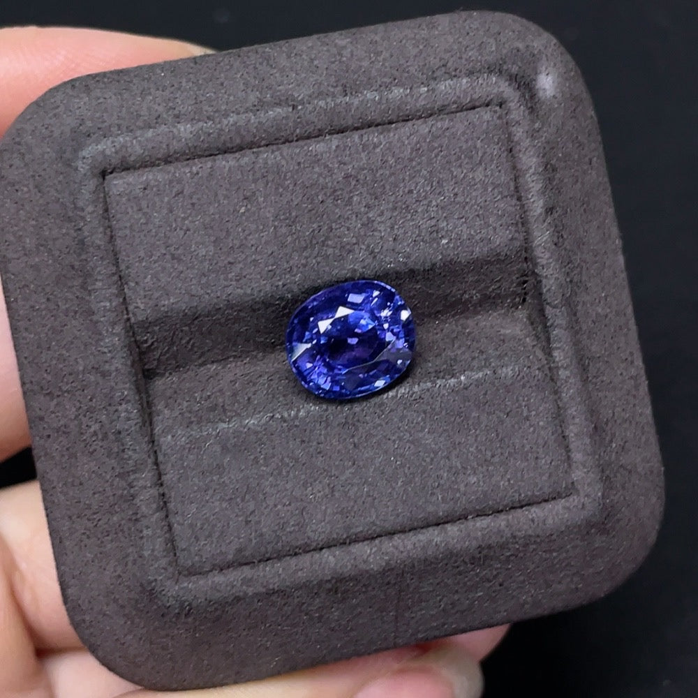 4.45-carat Tanzanite loose gemstone from HKHQ, showcasing vibrant blue-purple color and clarity in a jewelry setting.