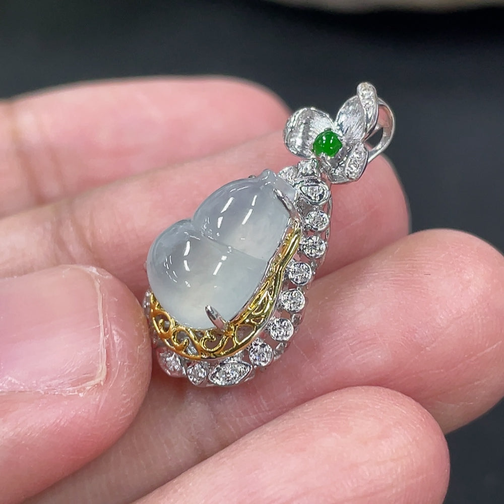 Jadeite gourd pendant with 18K gold and diamond accents, hanging on a necklace, showcasing intricate craftsmanship and elegant design.