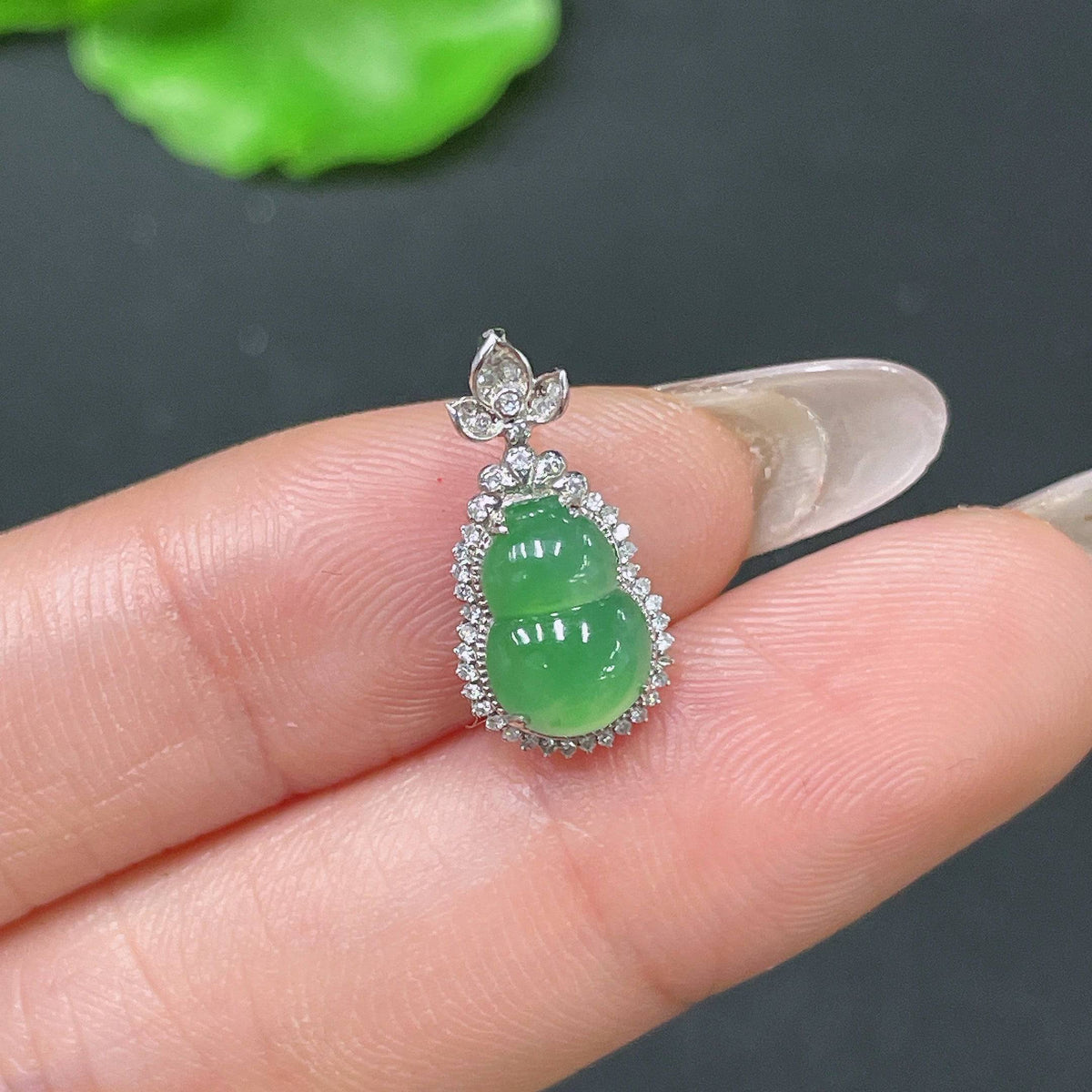 Jadeite gourd pendant with inlaid diamonds and 18k gold from HUILIU HQ, featuring intricate craftsmanship and a smooth polished surface.