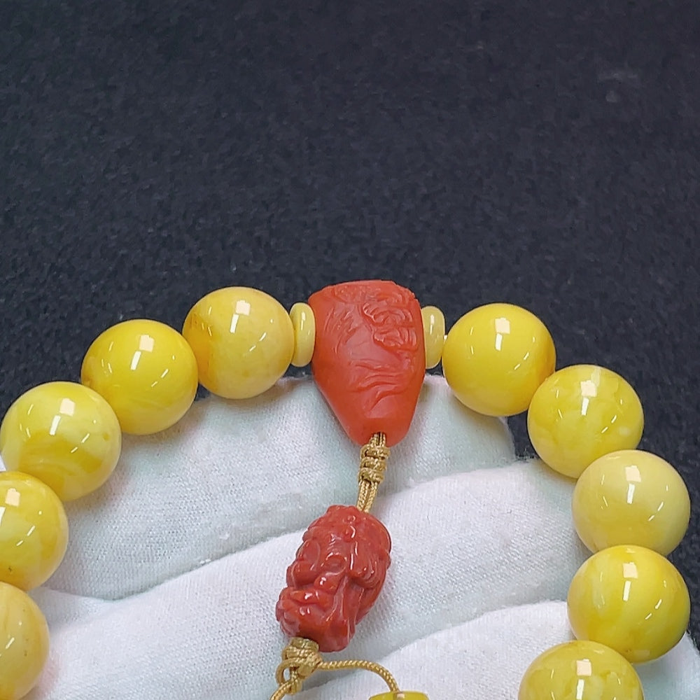 Amber and beeswax bracelet with a 13mm Southern Red Agate stone, crafted by HUILIU HQ, featuring natural and non-natural stone details.