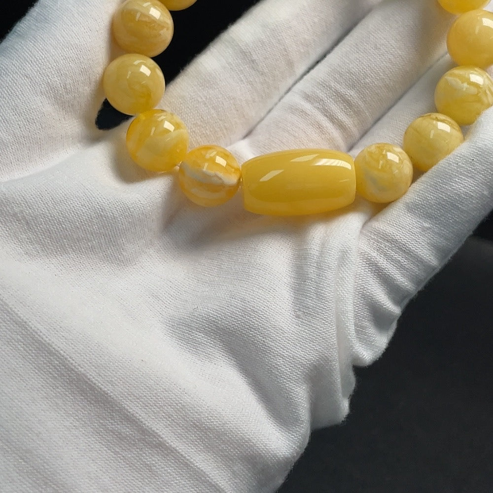 Huiliu certified amber beeswax bracelet, about 12.1mm size, showcasing warm amber beads on a stretch cord.