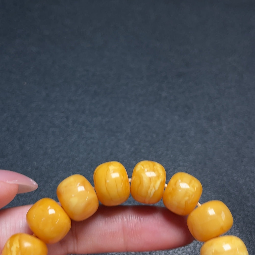 Amber Beeswax Bracelet by HUILIU HQ featuring bead with Southern Red Agate, natural amber and red stone accents.