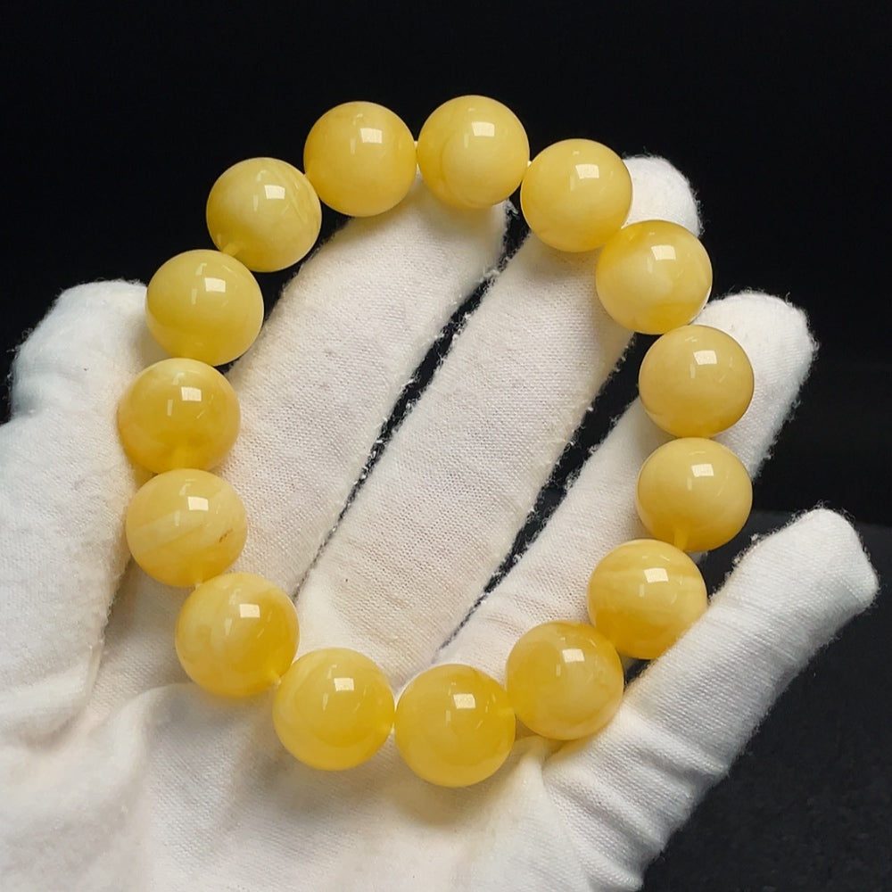 Huiliu certified amber beeswax bracelet with 14.1mm size, showcasing warm amber beads on a smooth elastic band.