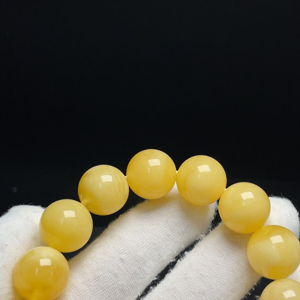 Huiliu certified amber beeswax bracelet, about 14.1mm in size, showcasing warm amber tones and smooth polished surface.