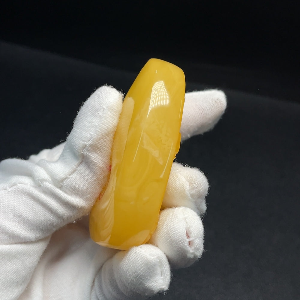 Amber beeswax pendant by HUILIU HQ with visible partial repairs, showcasing natural amber texture and craftsmanship.