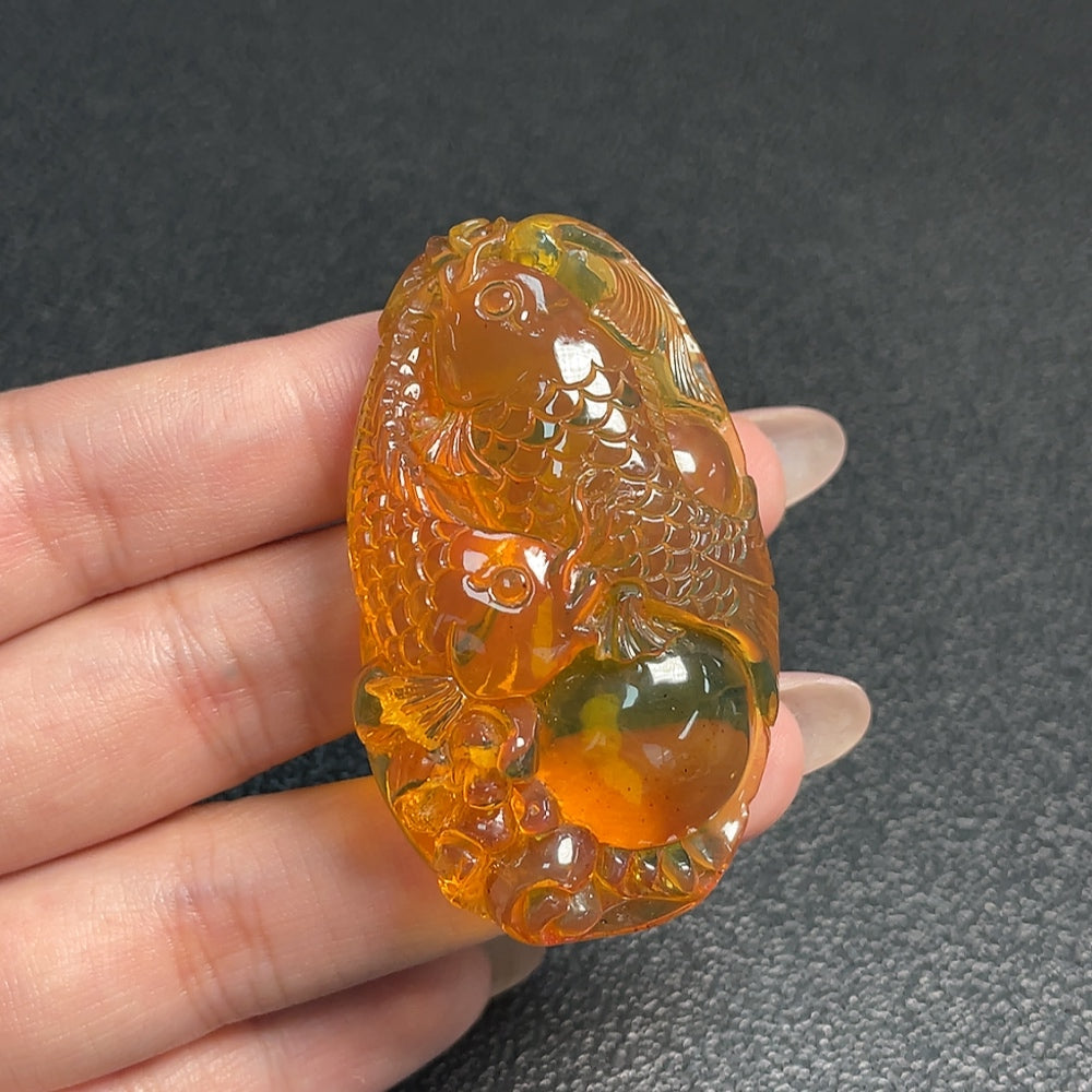 Amber honey wax pendant by HUILIU HQ, natural amber jewelry featuring a warm, translucent amber pendant on a string.