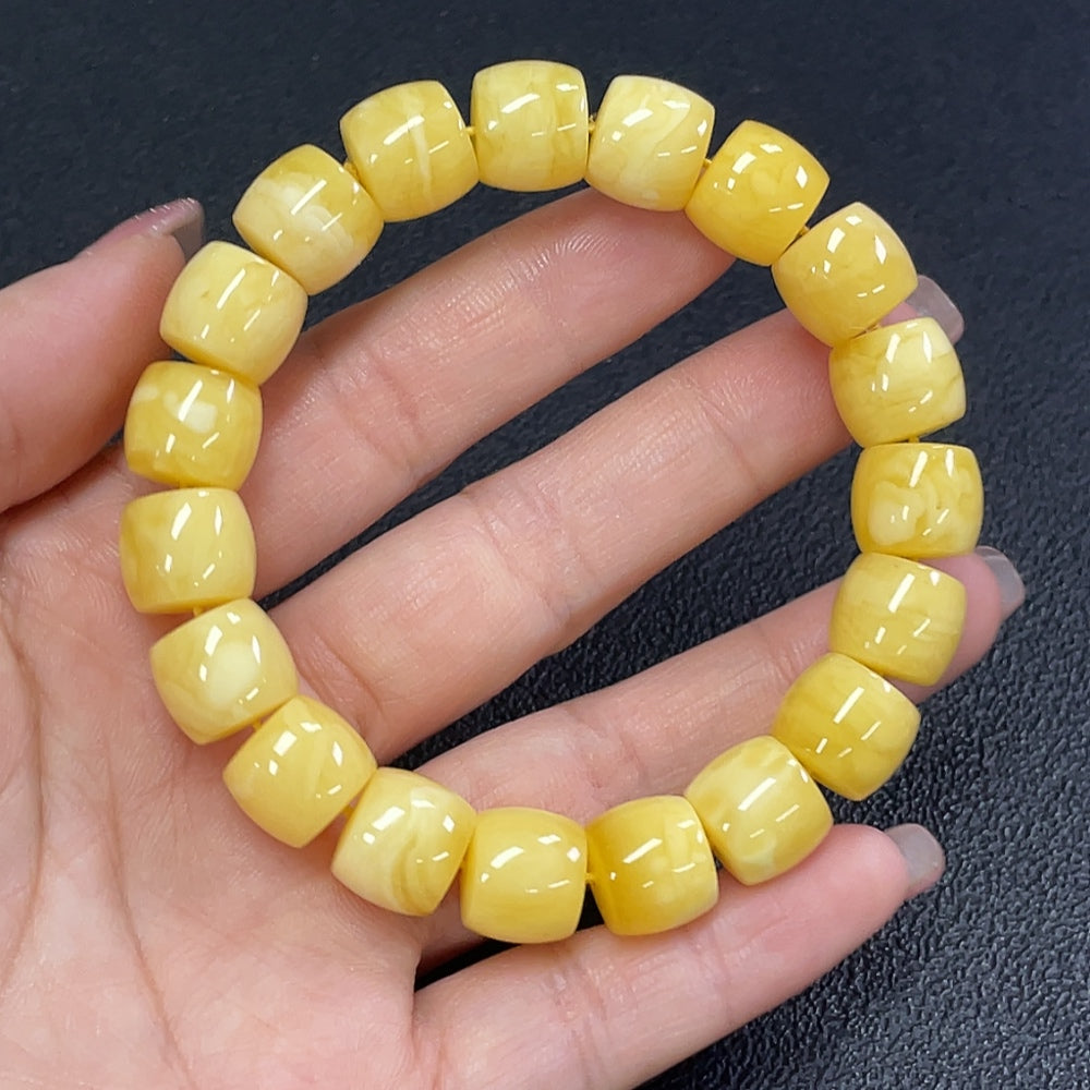 Natural Grade A Jadeite Amber Beeswax Bracelet by HUILIU HQ showing smooth amber beads on a string.