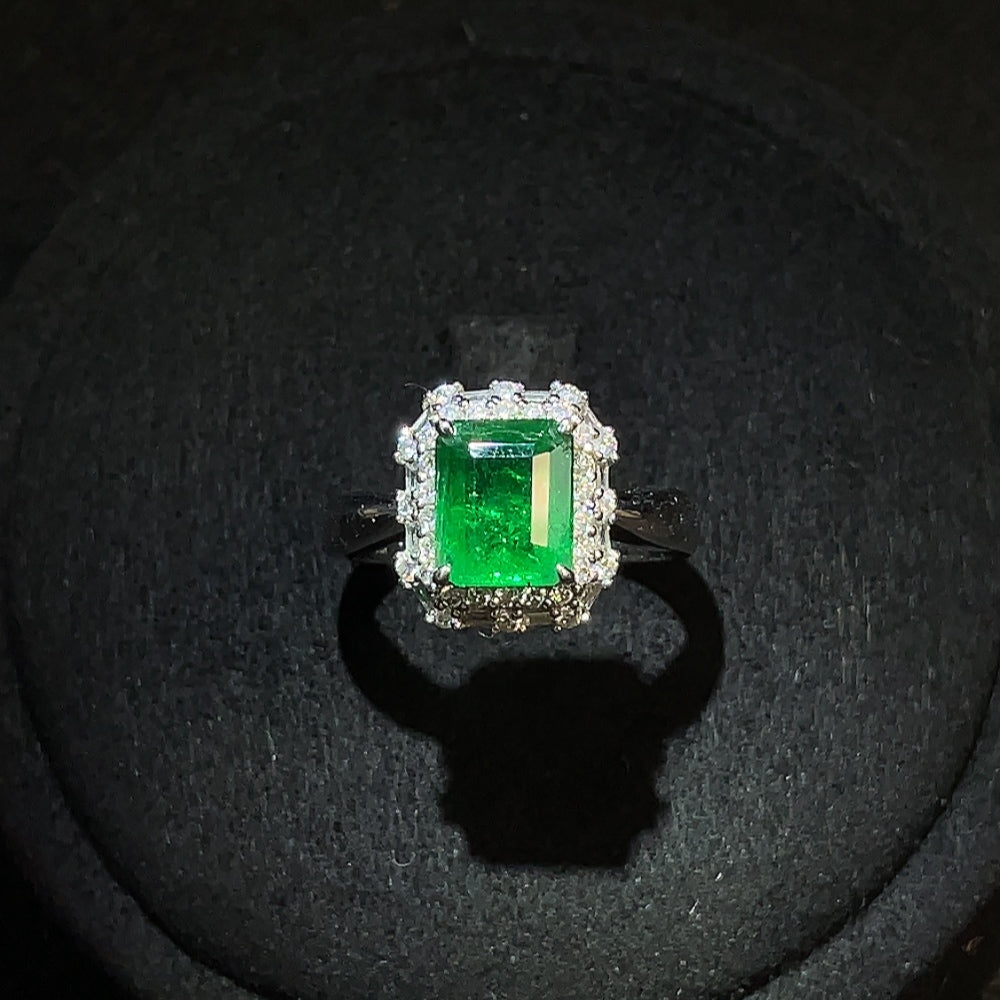 Emerald ring in 18K gold with diamond accents, size 13, featuring a clarity-enhanced emerald gemstone and intricate detailing.