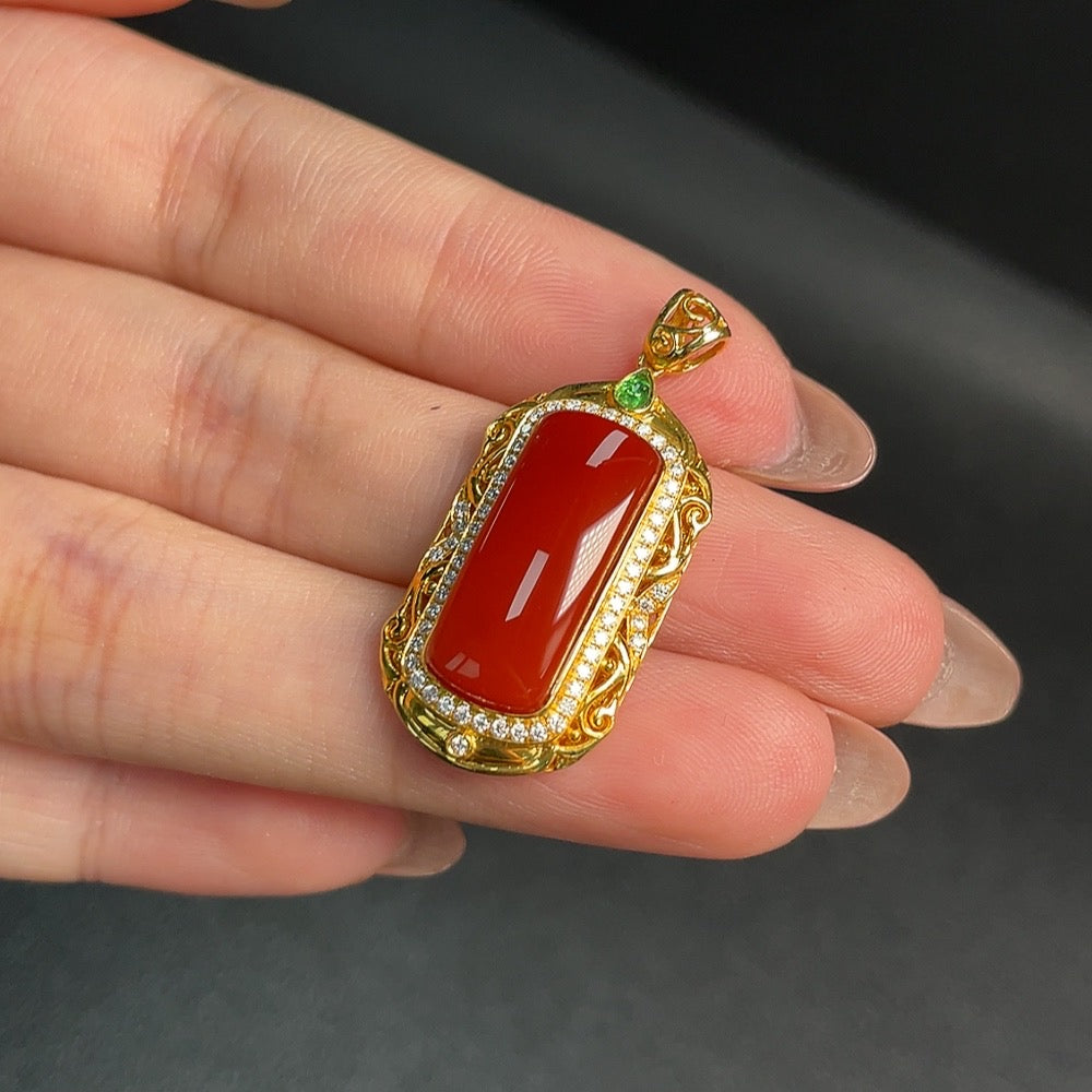 Huiliu Certified Red Agate gemstone pendant with smooth, polished surface, showcasing vibrant red color and natural stone texture.