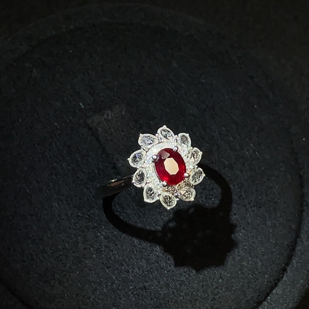 18k gold ruby ring with diamond accents, featuring a central ruby gemstone and subtle diamond details on the band.