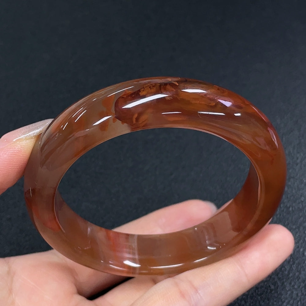 Huiliu Certified South Red Agate gemstone bracelet with visible organic matter, showcasing natural stone textures and earthy tones.