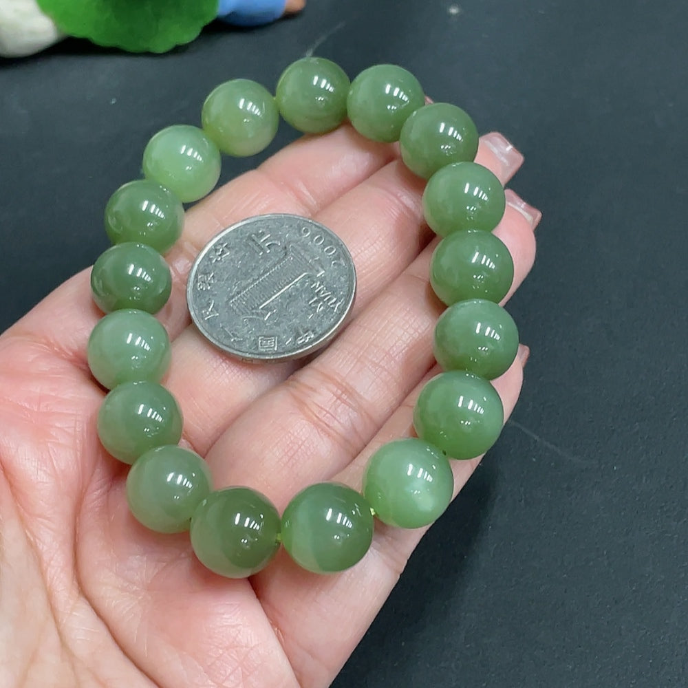 Huiliu certified Hetian Jade bracelet with 11.9mm beads, showcasing polished green jade beads on a delicate bracelet.