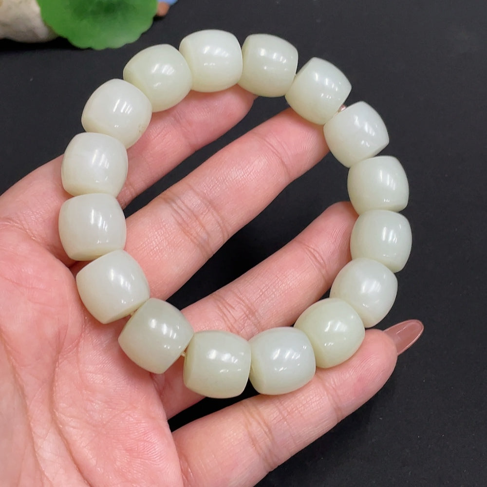Huiliu Hetian Jade bracelet with 13.5mm beads, natural green jade, certified Huiliu HQ, showcasing smooth, polished bead details.