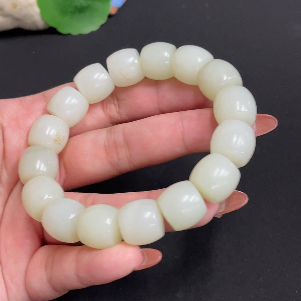 Huiliu Hetian Jade Bracelet with 13.5mm beads, natural green jade, certified Huiliu HQ, showcasing polished beads on a string.