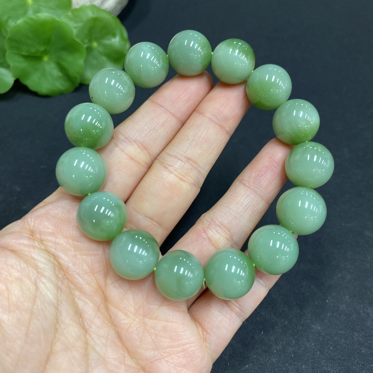 Huiliu certified Hetian jade bracelet with 13.5mm smooth, polished green jade beads, showcasing elegant craftsmanship.