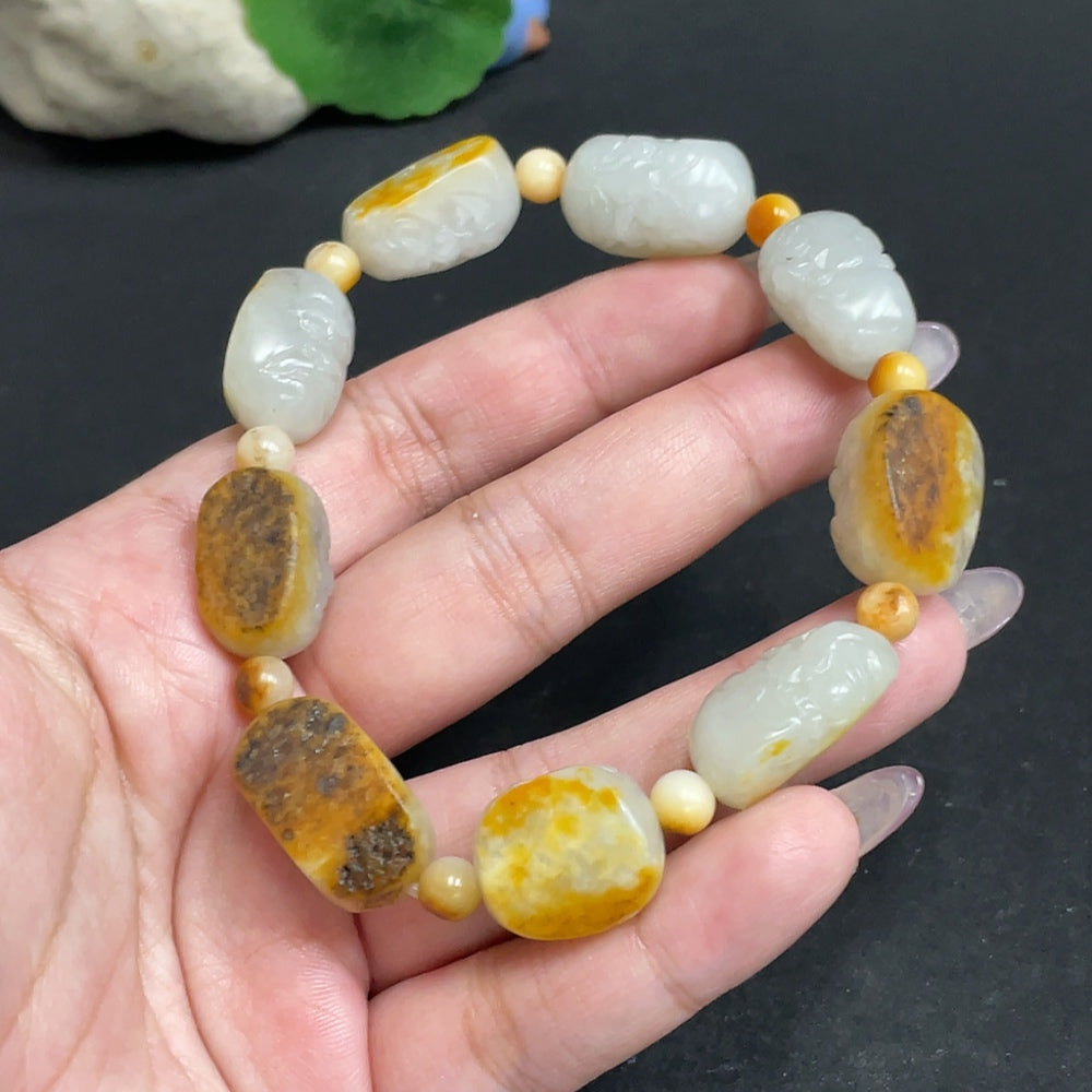 Huiliu certified Hetian Jade Eighteen Arhats bracelet featuring smooth jade beads and intricate carvings.