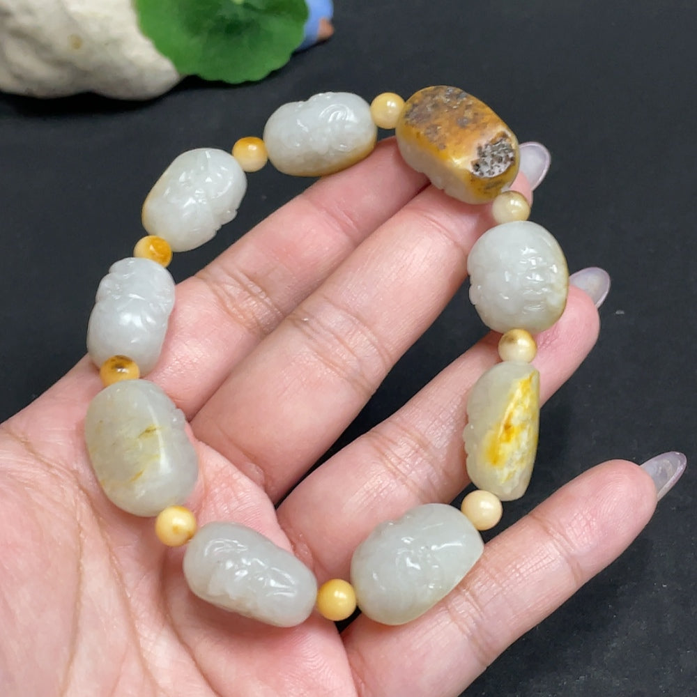 Huiliu HQ Hetian Jade Eighteen Arhats bracelet featuring smooth, polished jade beads on a natural jewelry piece.