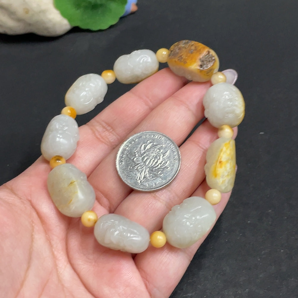 Huiliu HQ Hetian Jade Eighteen Arhats bracelet featuring polished jade beads with intricate carvings, certified by Huiliu.