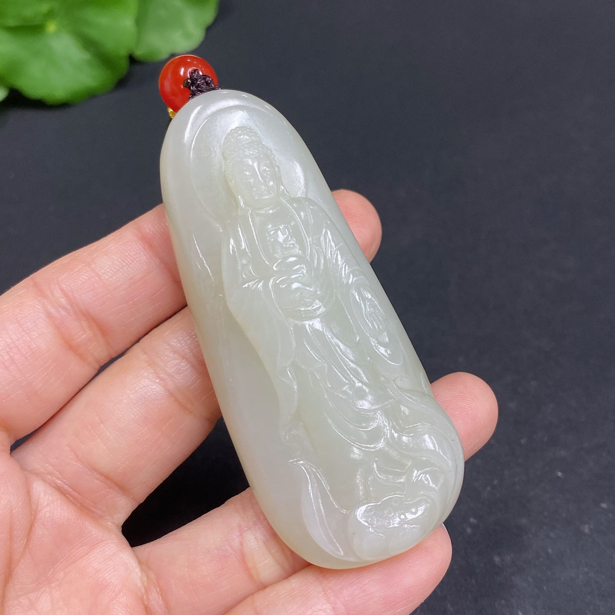 Hetian jade pendant featuring Amitabha Buddha, crafted by HUILIU HQ, showcasing a smooth, polished jade carving of the spiritual figure.