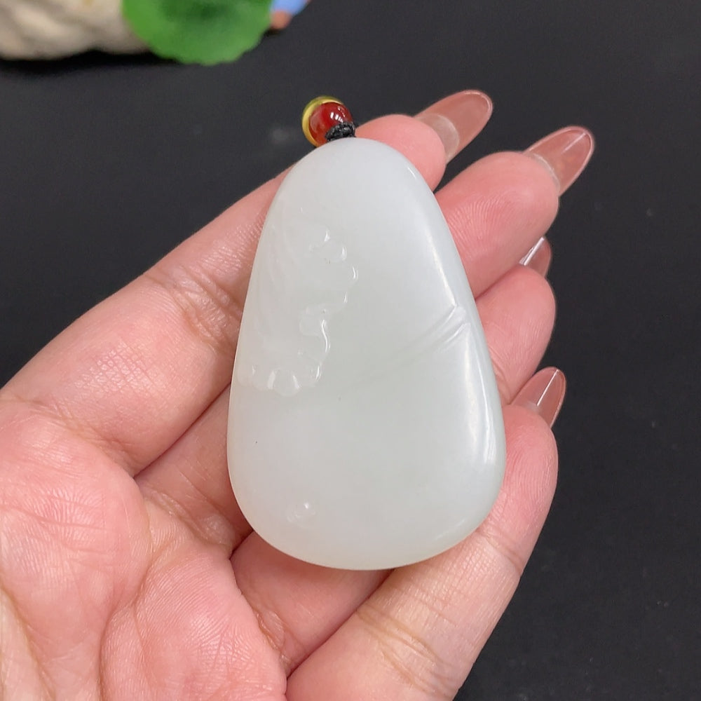 Huiliu certified Hetian jade Buddha pendant with woven rope, featuring intricate carved details and smooth polished surface.
