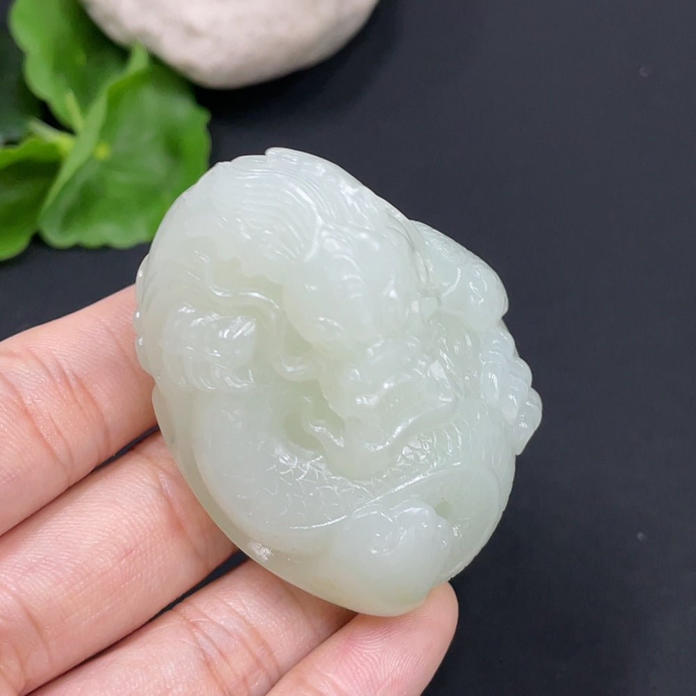 Hetian jade dragon pendant from HUILIU HQ with collection card, showcasing detailed carved jade craftsmanship.