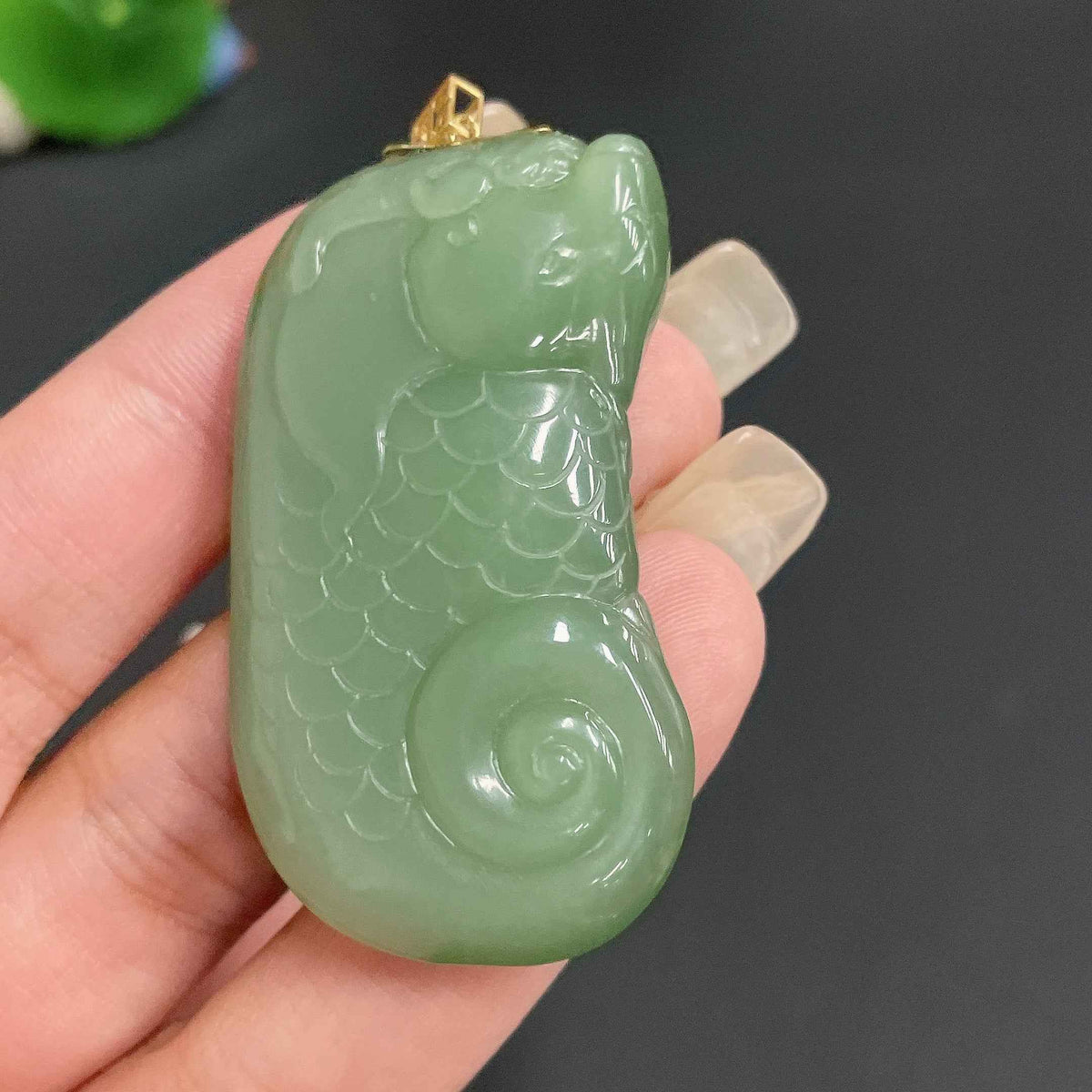 Hetian Jade pendant featuring a dragon fish design with an 18K gold clasp, weighing approximately 24.4g.