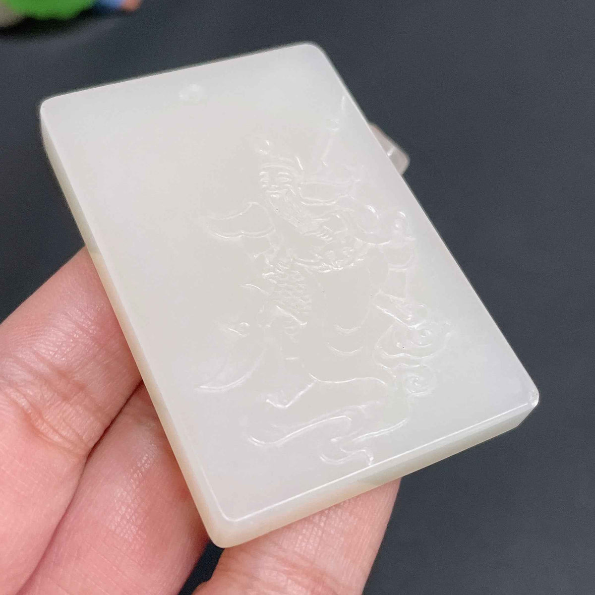 Huiliu certified Hetian jade pendant featuring Guan Gong figure, crafted from smooth green jade with intricate details.