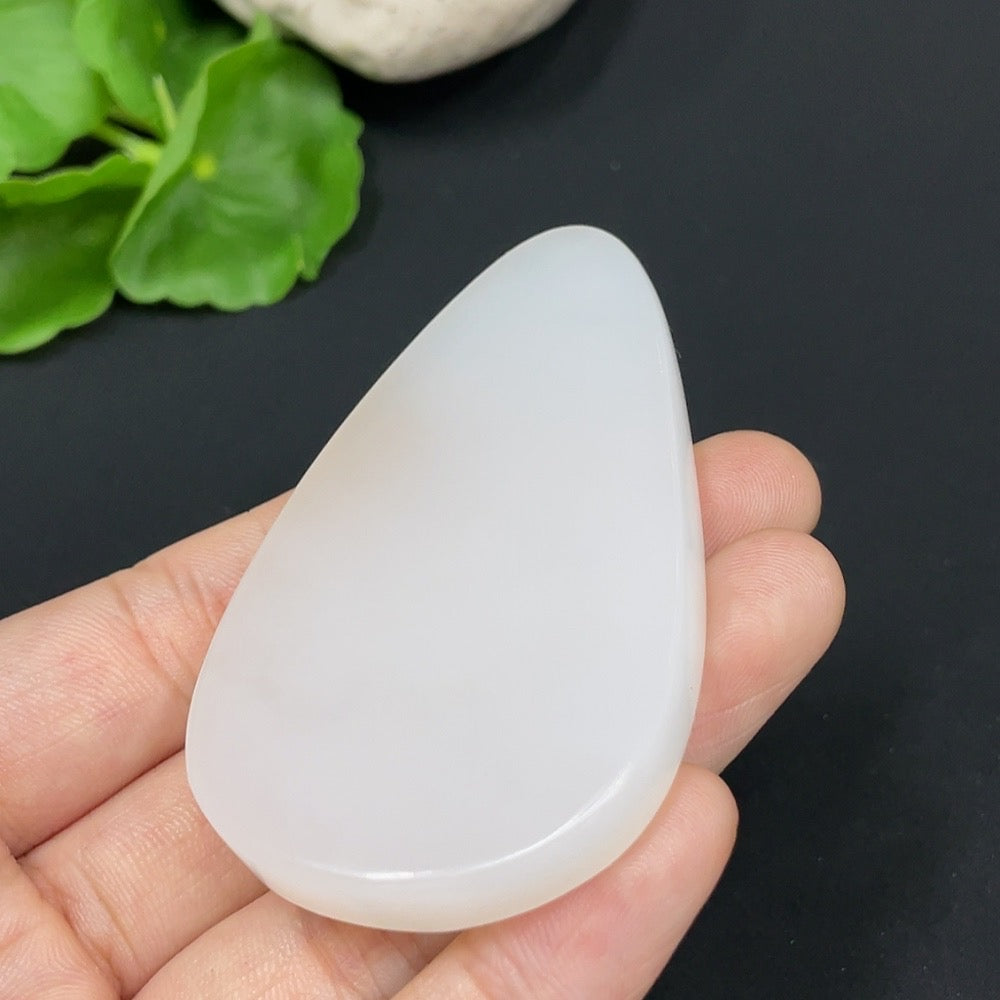 Huiliu Certified Hetian Jade Pendant featuring Guanyin, intricately carved, natural jade with detailed craftsmanship.