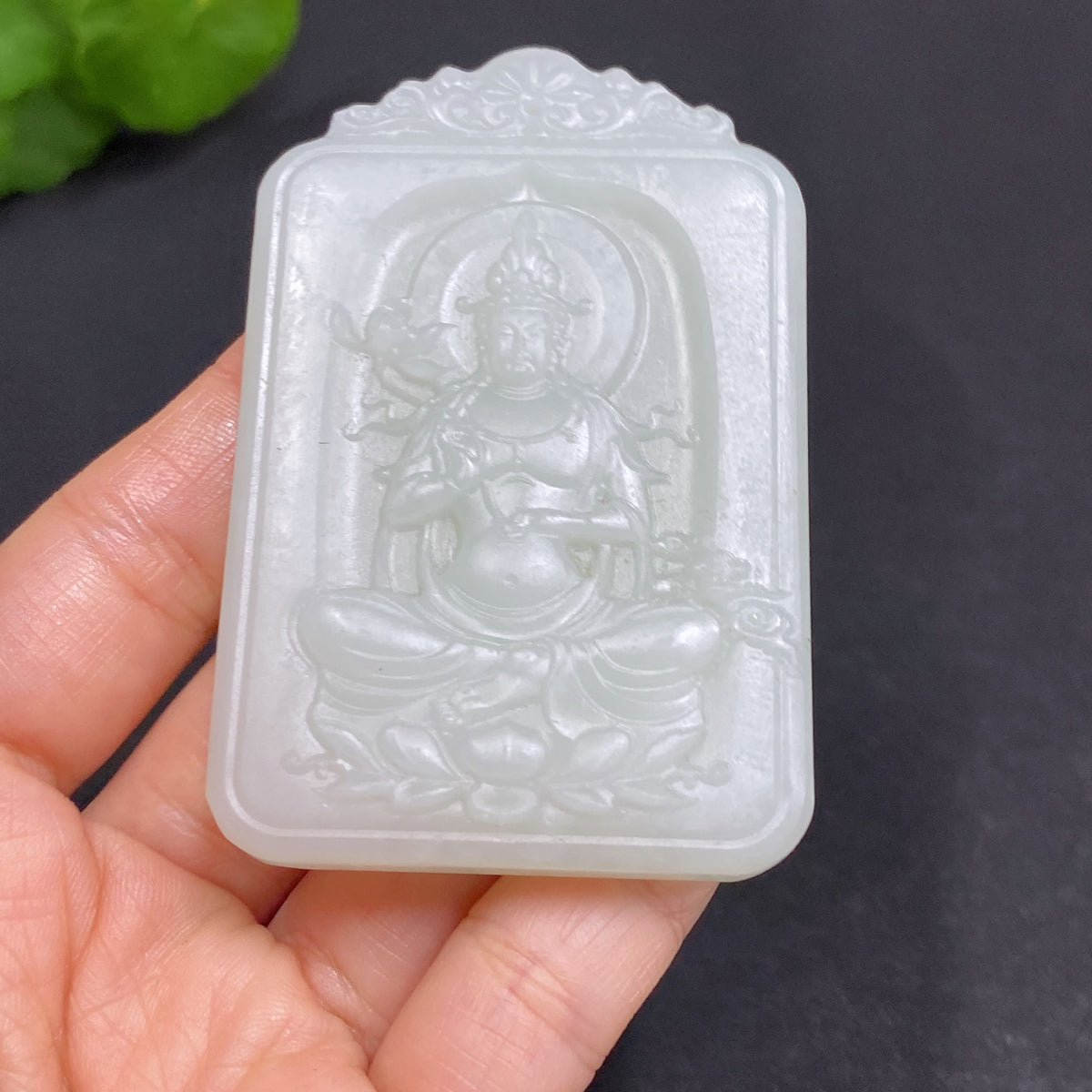Huiliu certified Hetian jade pendant featuring Guanyin figure, smooth polished surface, and intricate carved details.