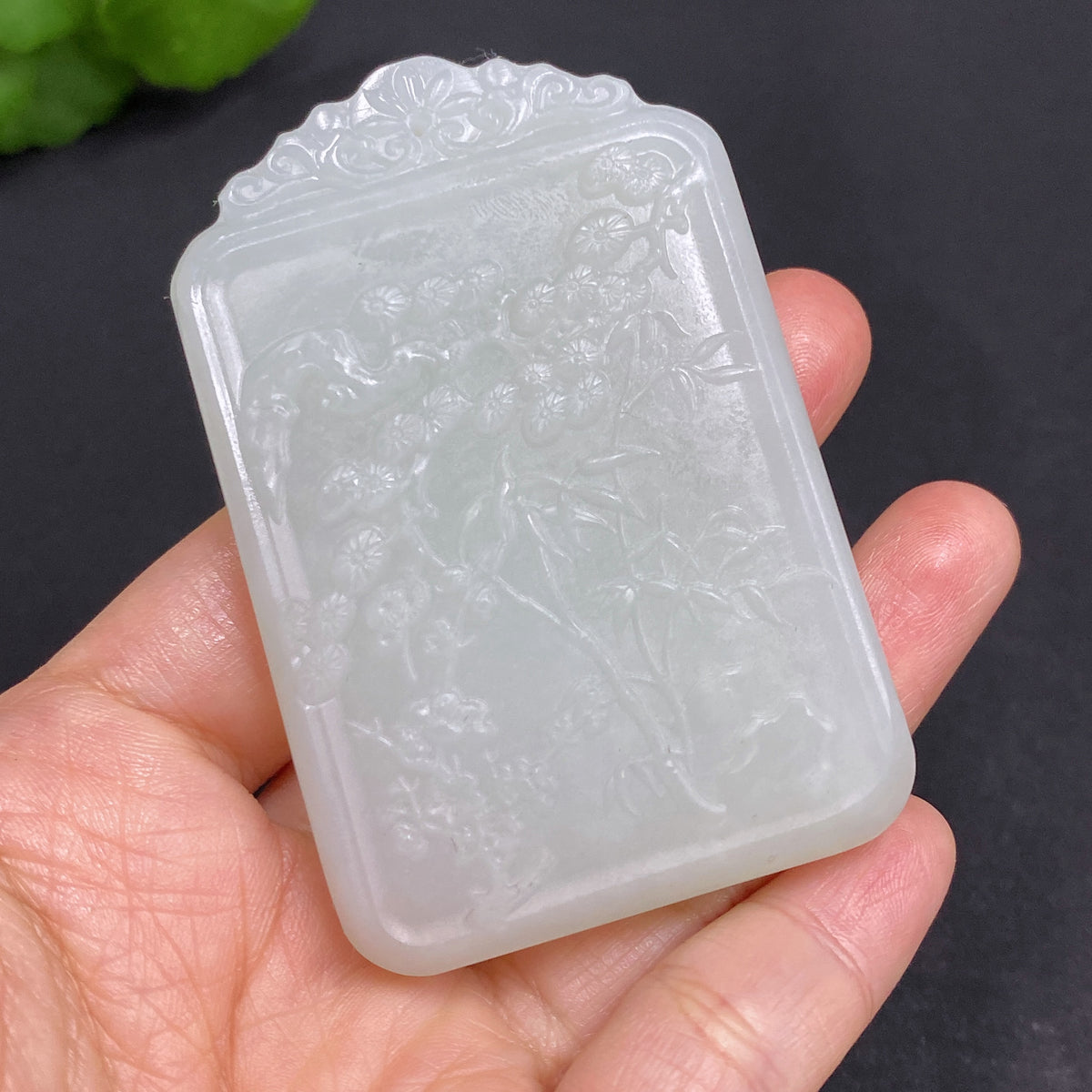 Huiliu certified Hetian jade pendant featuring Guanyin figure, showcasing intricate craftsmanship and smooth jade surface.