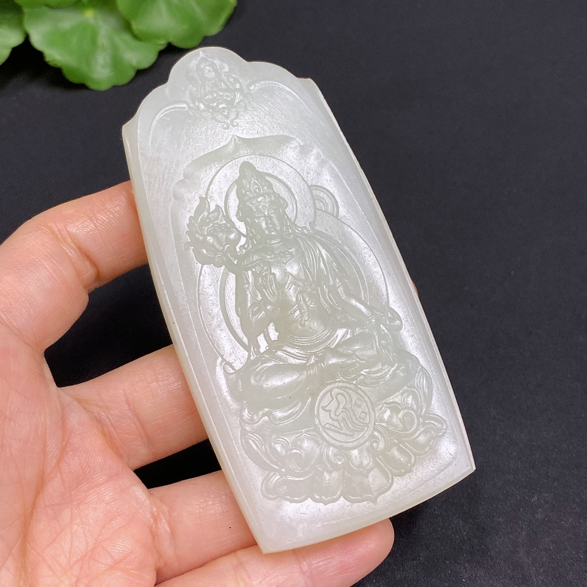 Huiliu certified Hetian jade Guanyin pendant showcasing intricate carvings and smooth, polished green jade surface.