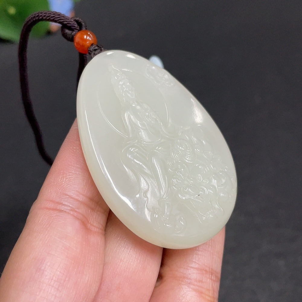 Huiliu certified Hetian jade Guanyin pendant showcasing intricate carvings and smooth, polished surface.