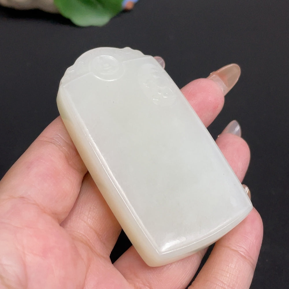 Huiliu certified Hetian jade pendant featuring a Guanyin figure, smooth polished surface with intricate carving details.
