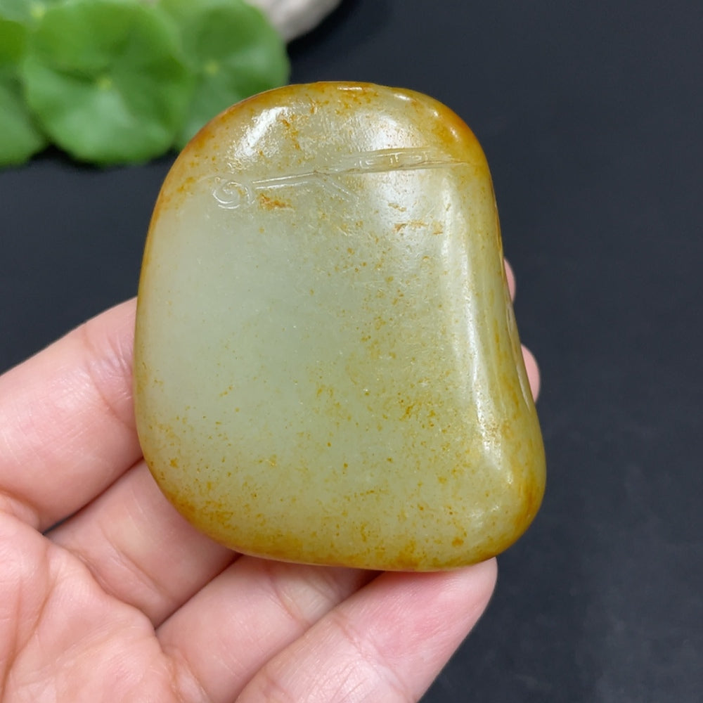 Huiliu certified Hetian jade pendant featuring Guanyin figure, intricately carved and polished for elegant jewelry.