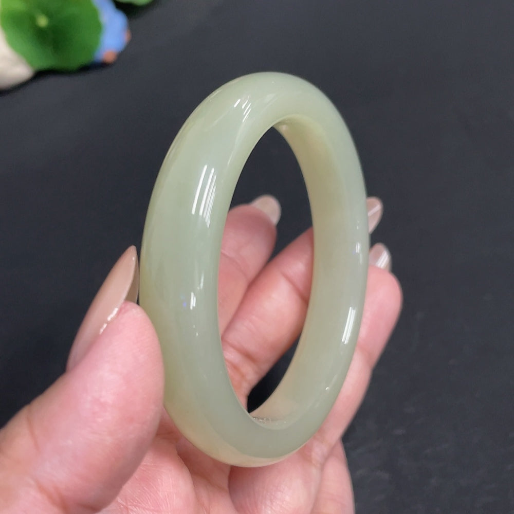 Huiliu Certified Hetian Jade Round Bangle showcasing smooth, polished jade with a natural green hue and rounded shape.