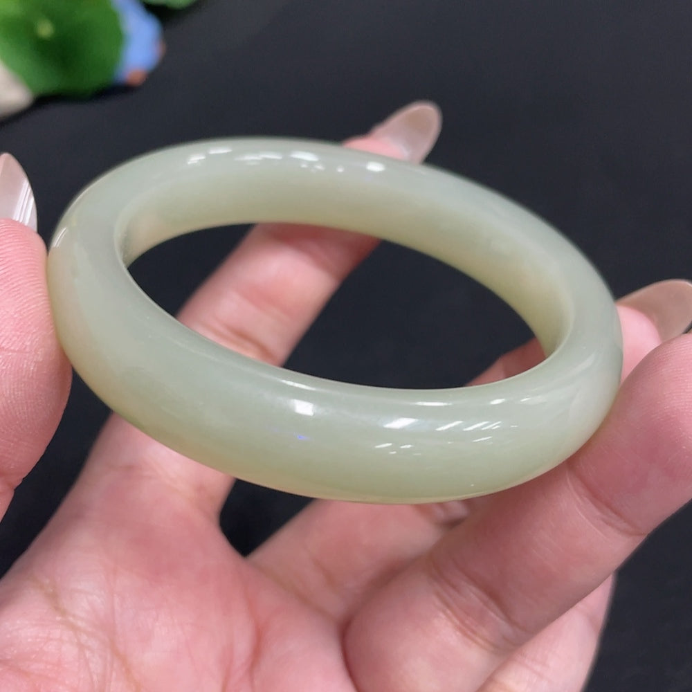 Huiliu Certified Hetian Jade round bangle showcasing smooth, polished jade with natural green hues and subtle variations.